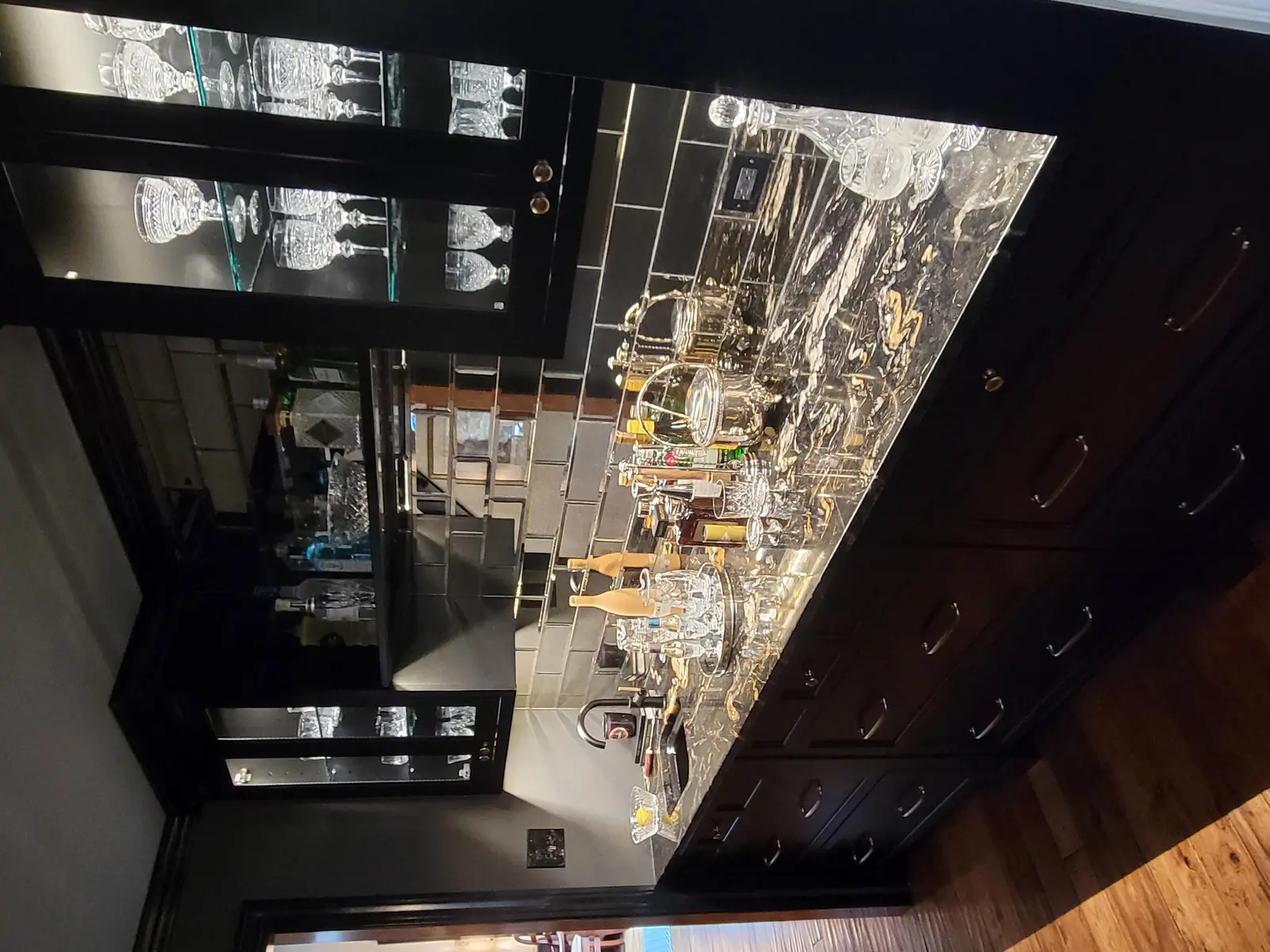 Finished basement bar with mirror backsplash