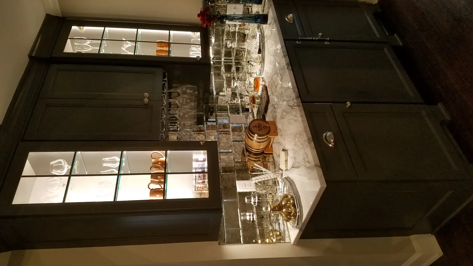 Finished basement bar with glass display cabinets