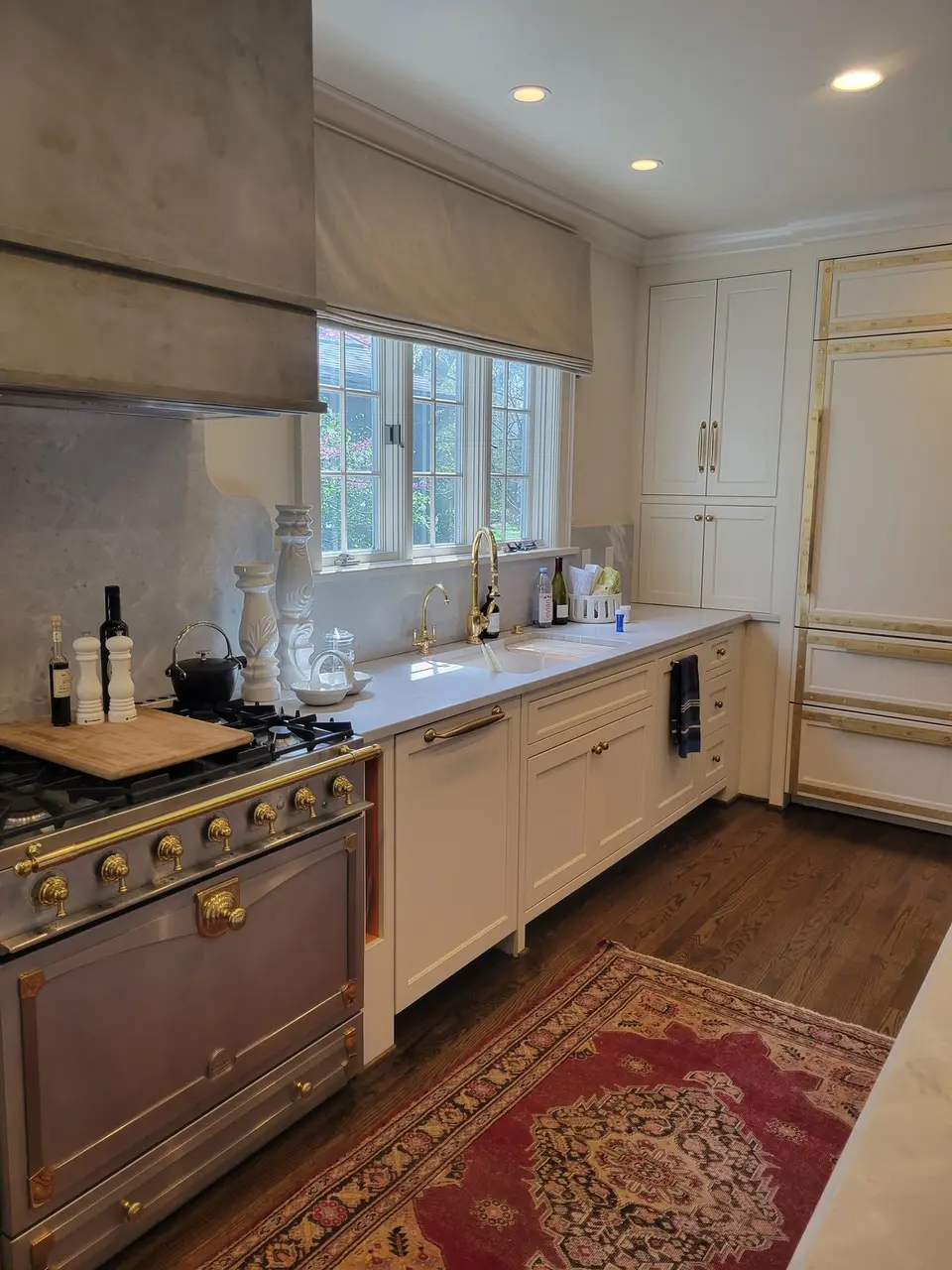 White kitchen with brass La Cornue range